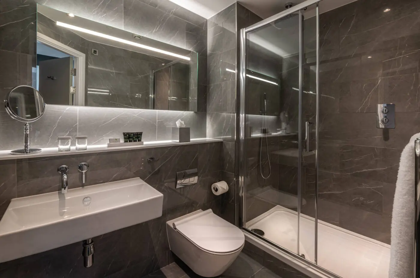 A bathroom with a walk-in shower