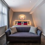 A junior suite with a double bed and sofa, located in Covent Garden.