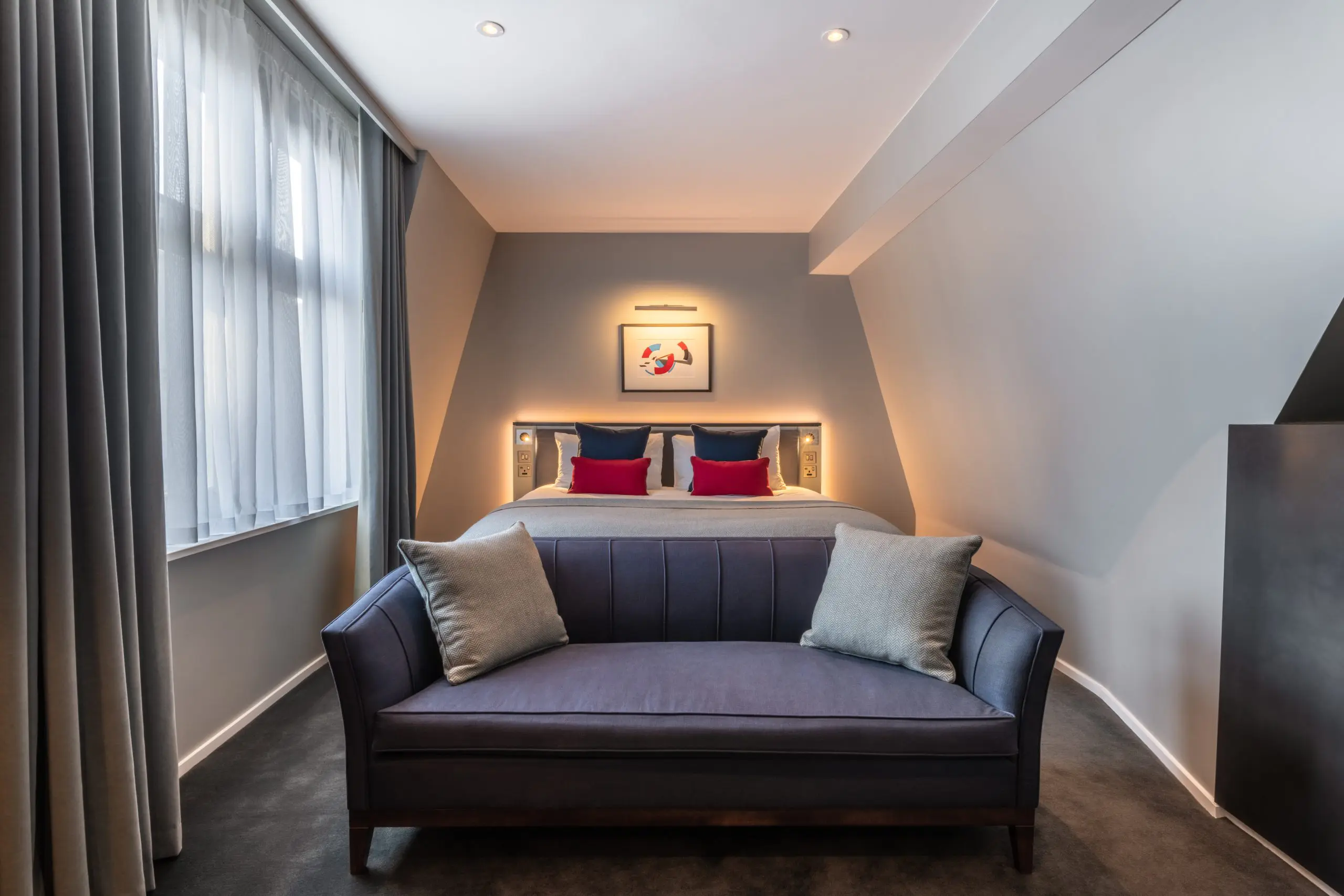 A junior suite with a double bed and sofa, located in Covent Garden.