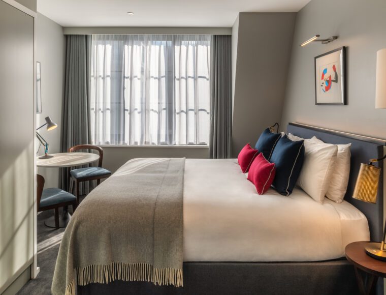 A king room with a dining table and double bed, located in Covent Garden.