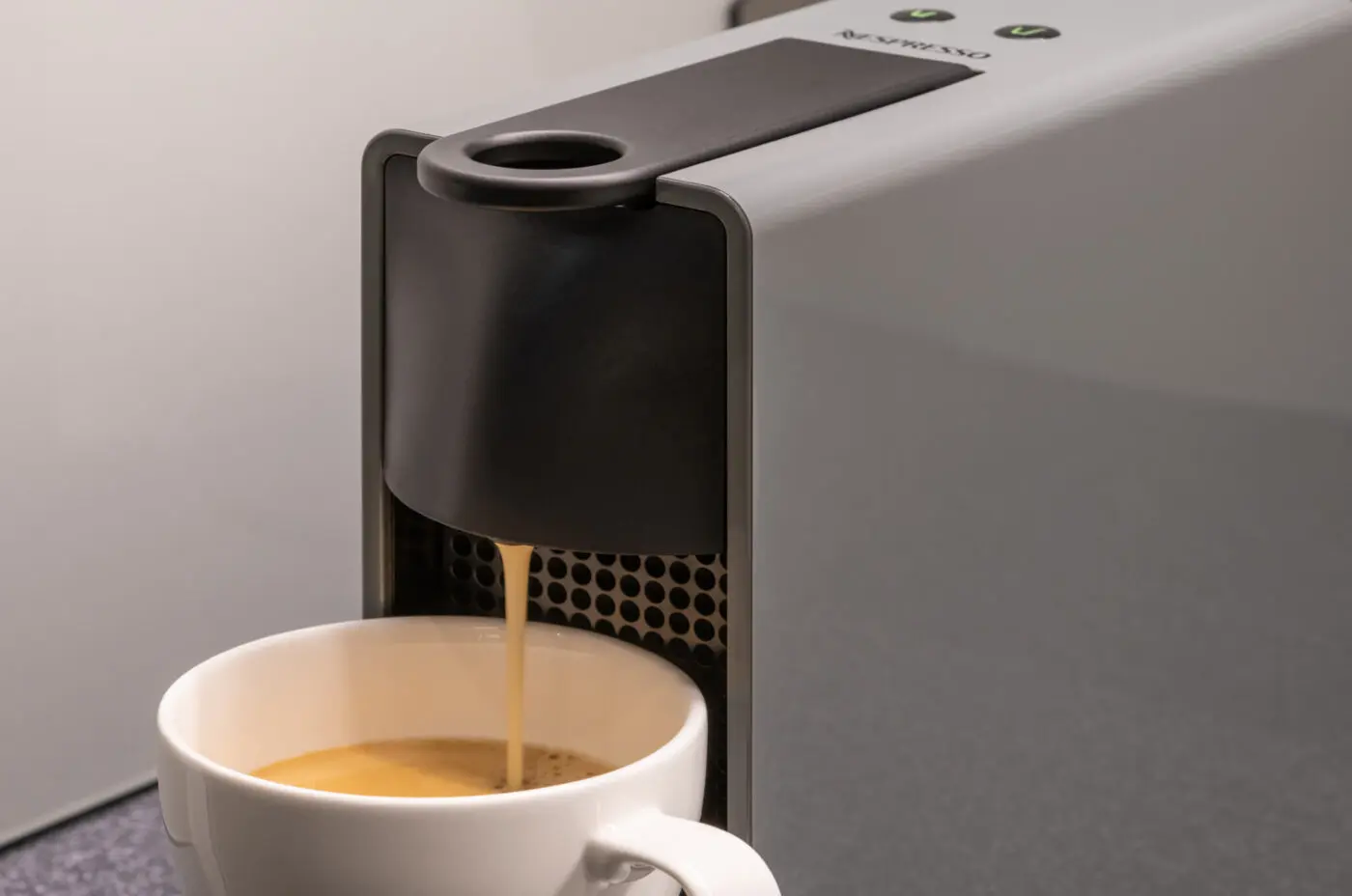 Coffee machine, pouring a hot beverage into a mug.