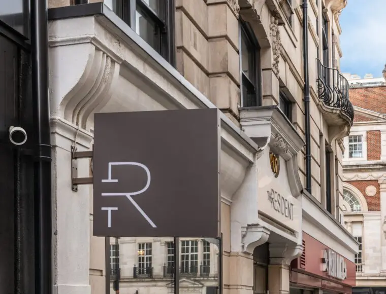 A hanging sign of The Resident Covent Garden.