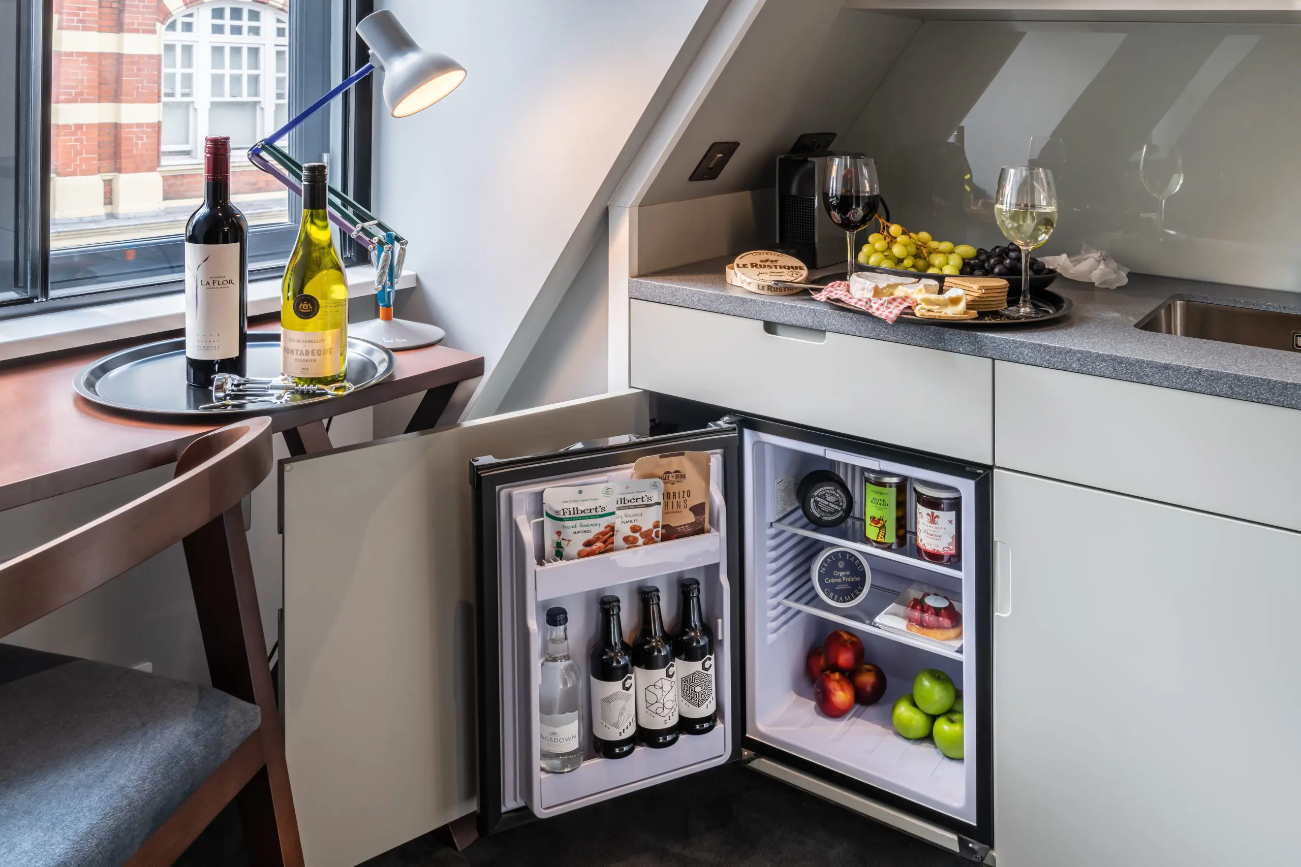 A miniature kitchen area with a built in fridge, in Covent Garden.