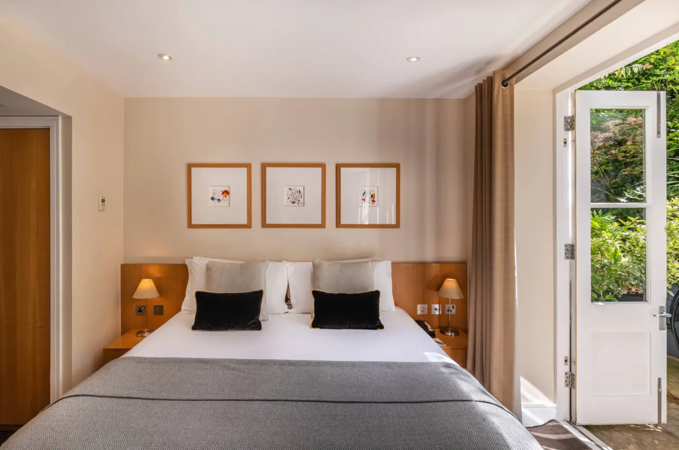 A superior room with a double bed and bedside tables