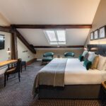 A deluxe room, with a double bed, television and desk, located in Liverpool.