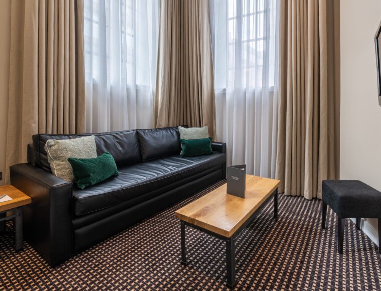 A junior suite lounge with a sofa and coffee table.
