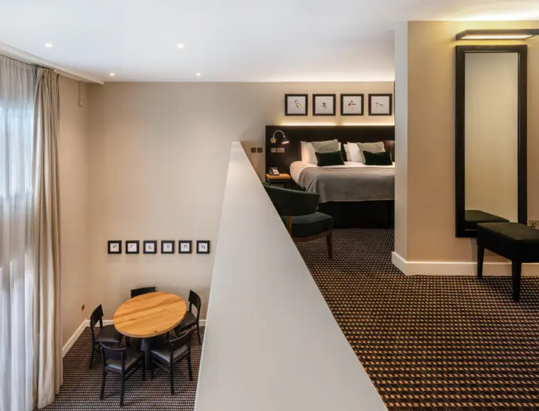 A two-level suite, with a bedroom at the top and dining space below, located in Liverpool.