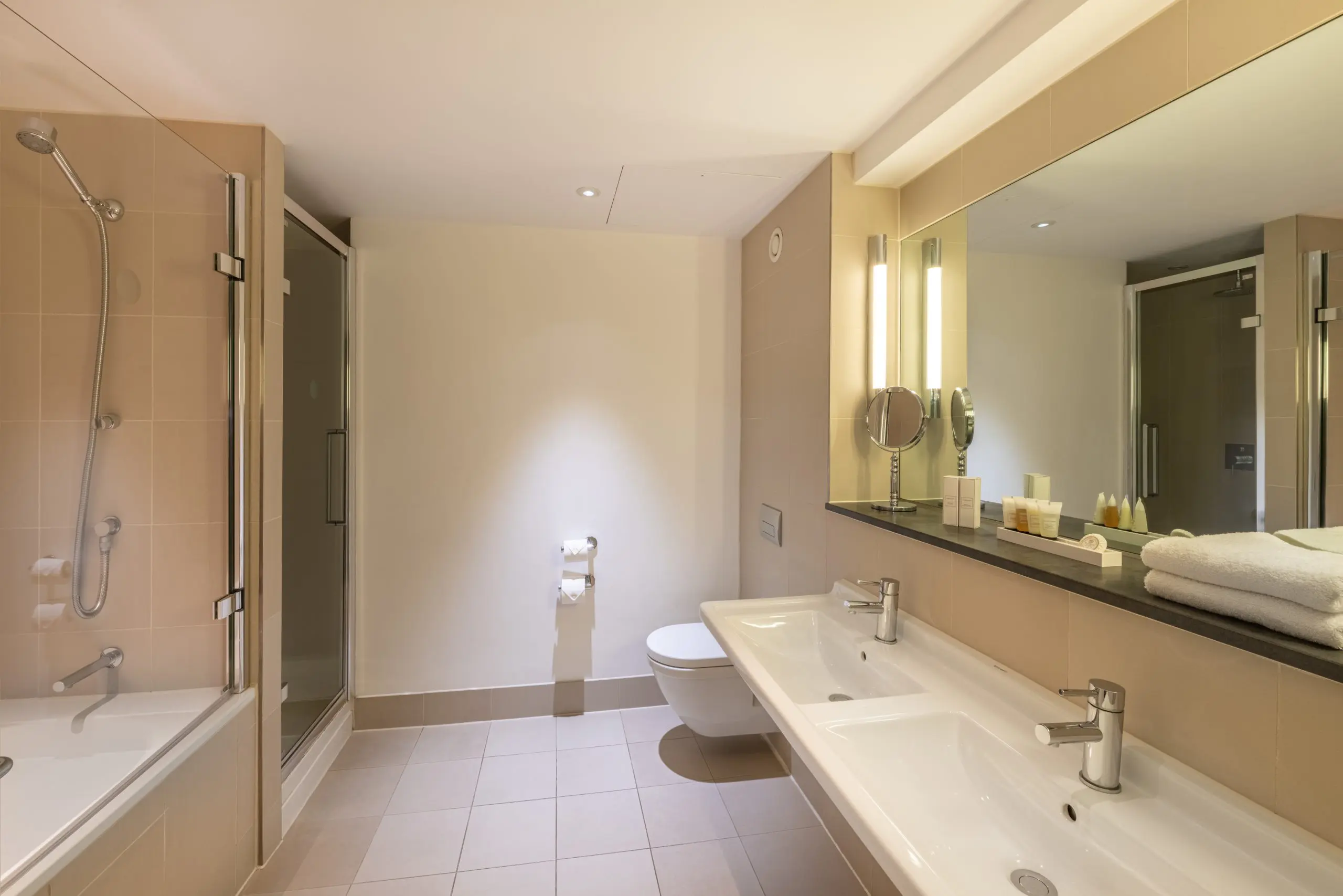 A large bathroom with a shower, bathtub and two sinks, located in Liverpool.