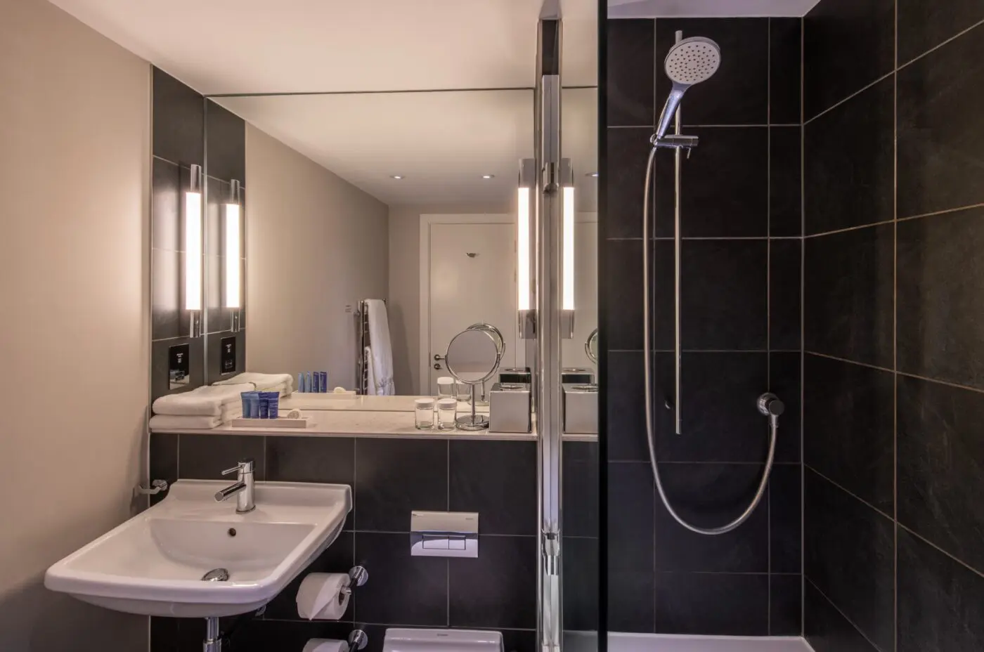 A small bedroom with a walk-in shower.