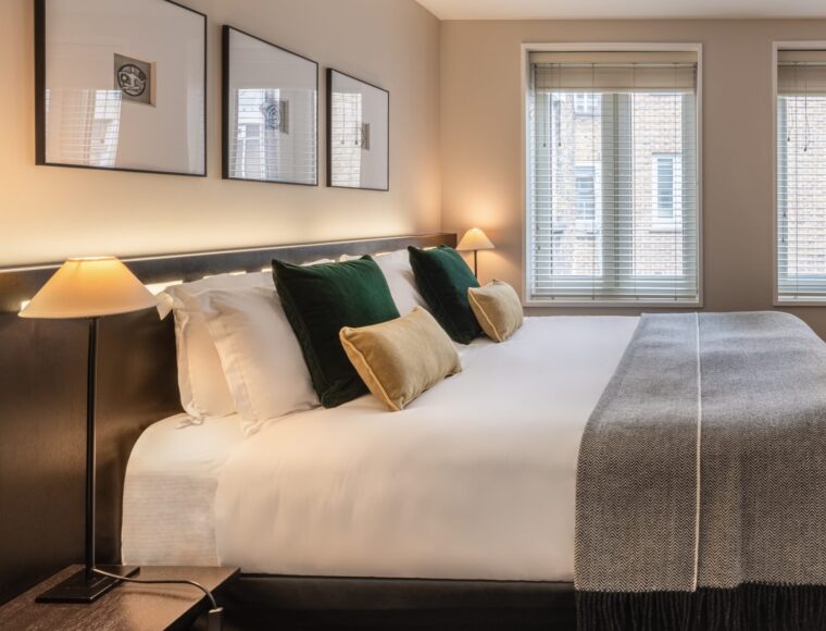 King sized suite, with a desk and television.