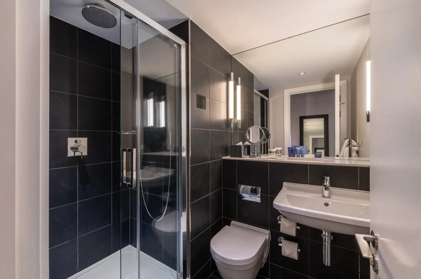 A single room bathroom with a walk-in shower, located in Soho.