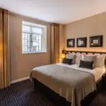 A suite with a double bed and bedside tables, located in Victoria.