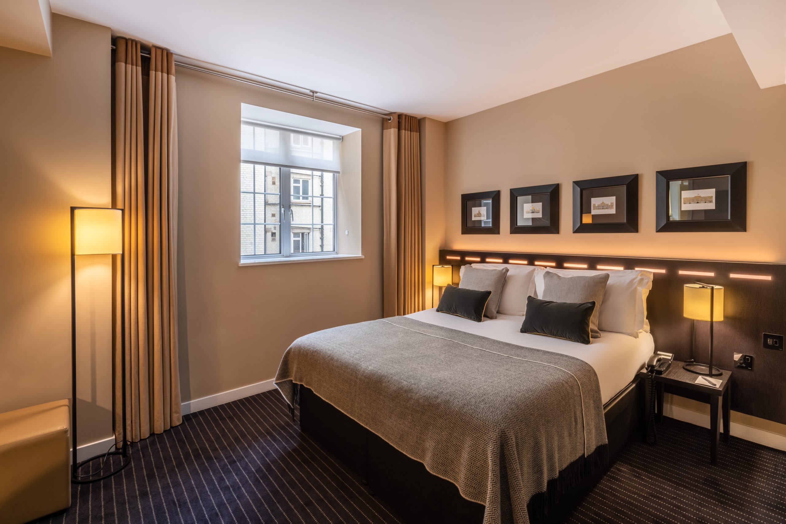 A suite with a double bed and bedside tables, located in Victoria.