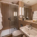Bathroom with a walk-in shower and amenities.