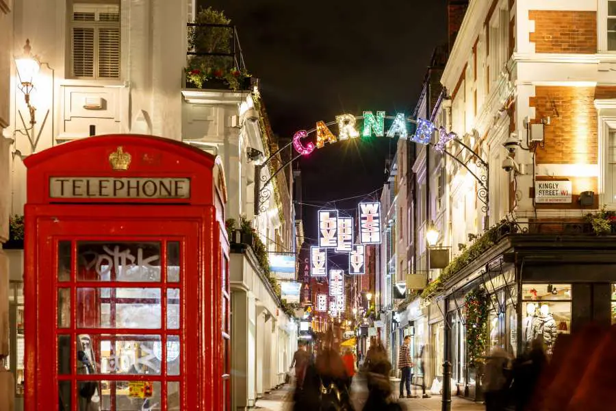 An entrance into Carnaby Street, with a red telephone box.