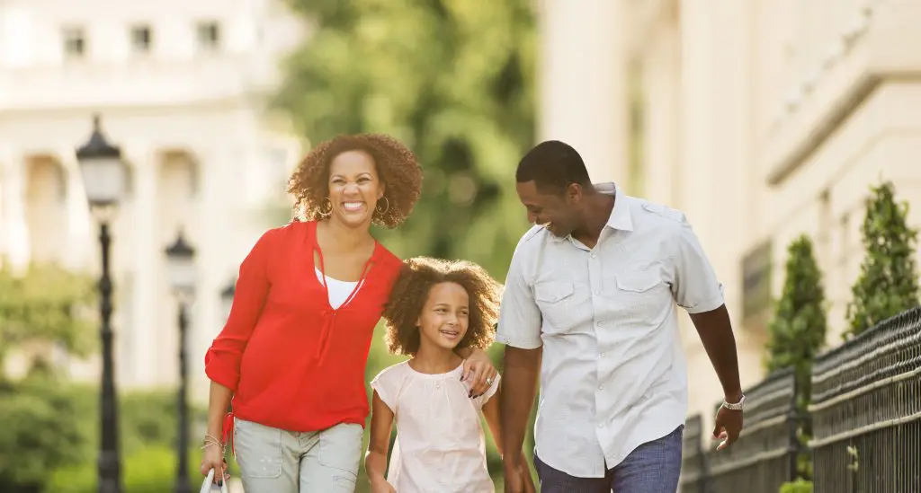 A happy family walking through Kensington.