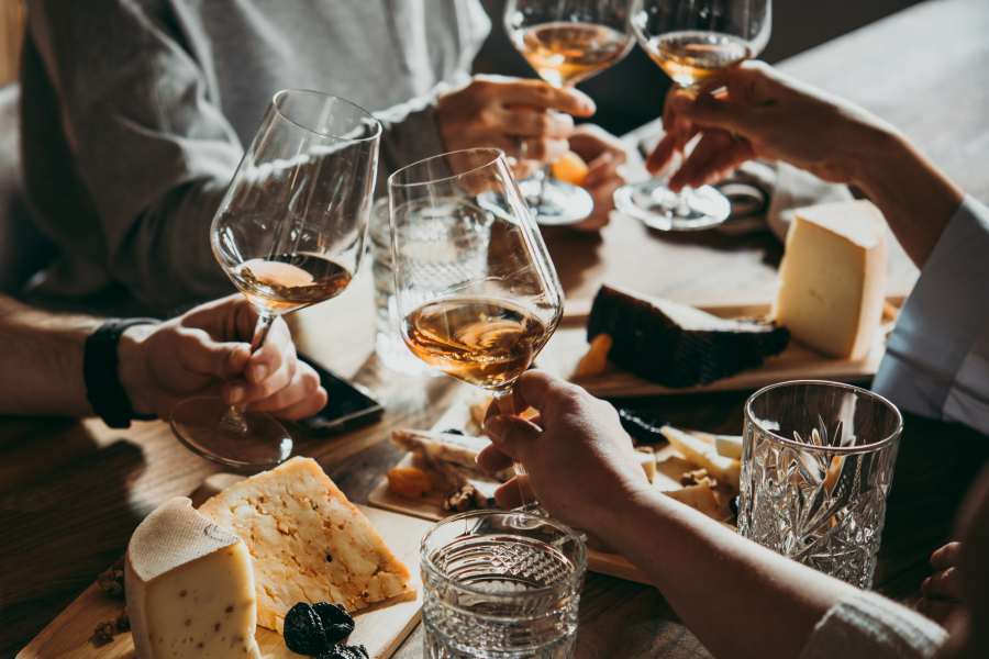 Individuals cheering with glasses of wine