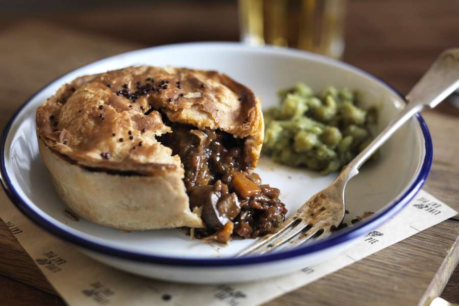 A meat and vegetable pie with mushed peas, served by Pieminister.