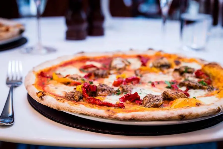 A plate of pizza, served by The Italian Club.