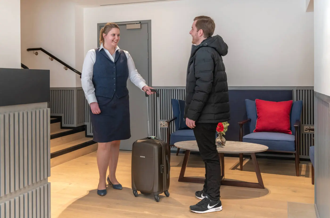 Hotel Professional welcoming a new customer into the hotel