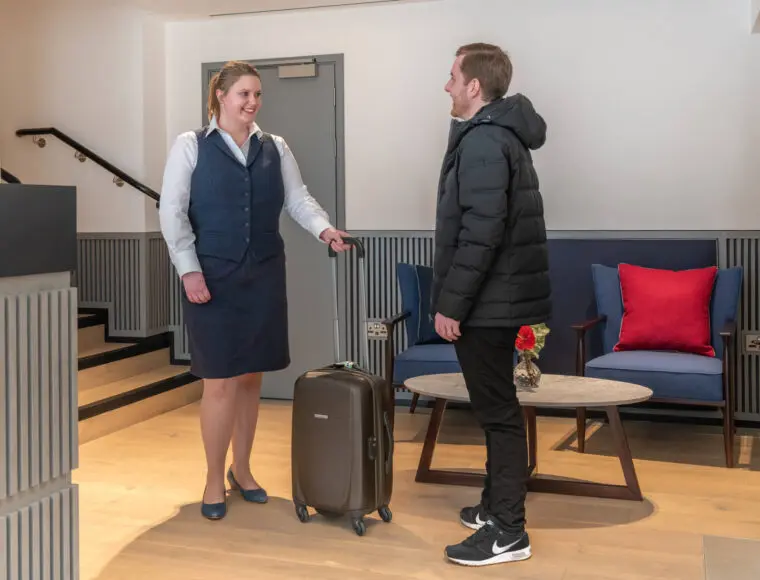 Hotel Professional welcoming a new customer into the hotel