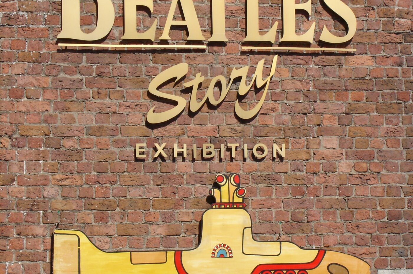 The Beatles Story Logo against a brick wall