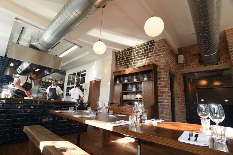 Dining area and open kitchen, at Wreckfish restaurant.