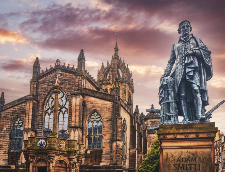 St Giles Cathedral in Edinburgh at sunset, featuring the statue of Adam Smith,