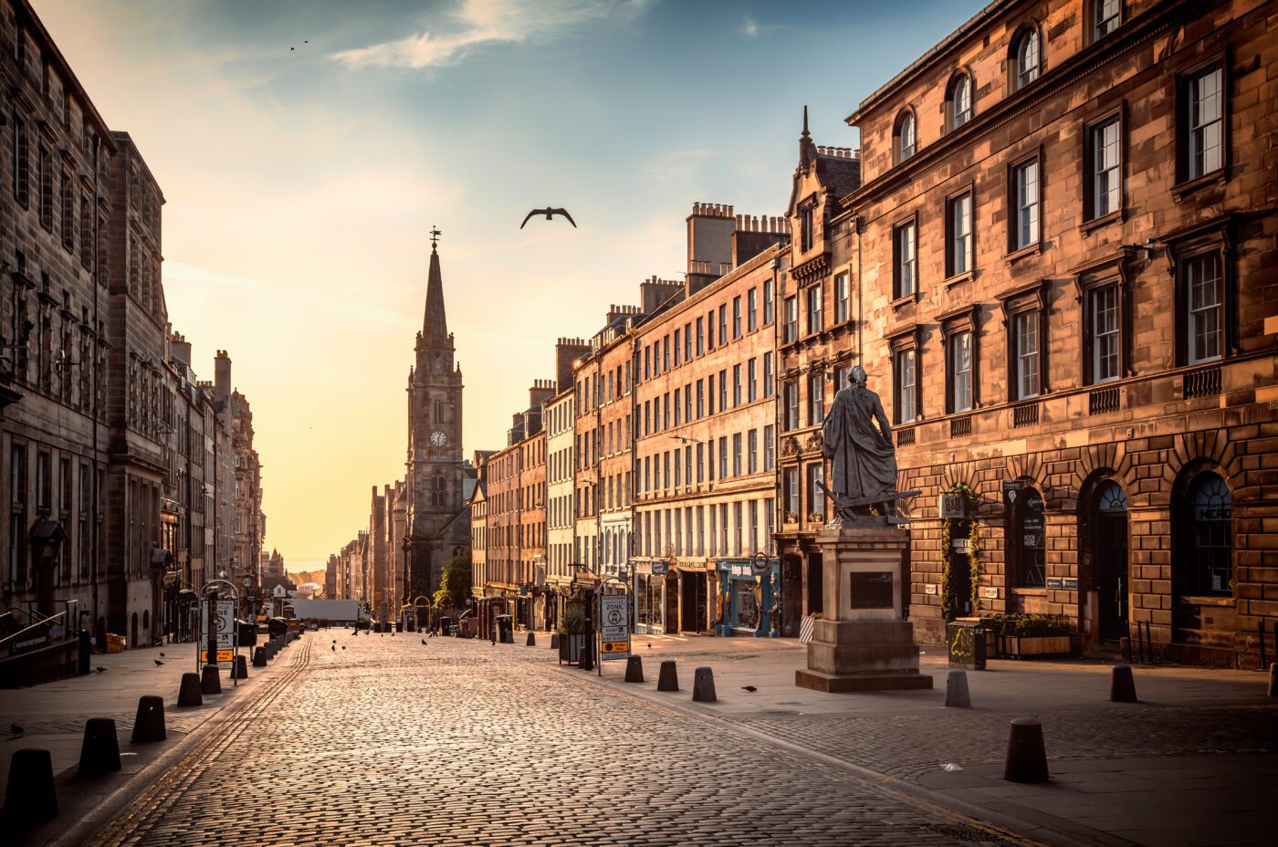 The view of the Royal Mile and the Adam Smith Statue in the sunrise hours