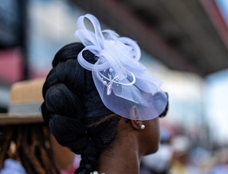 A guest at a Buckingham Palace Garden party wearing a fancy hat.