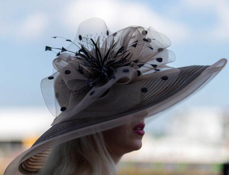 A guest at a Buckingham Palace Garden party wearing a fancy hat.