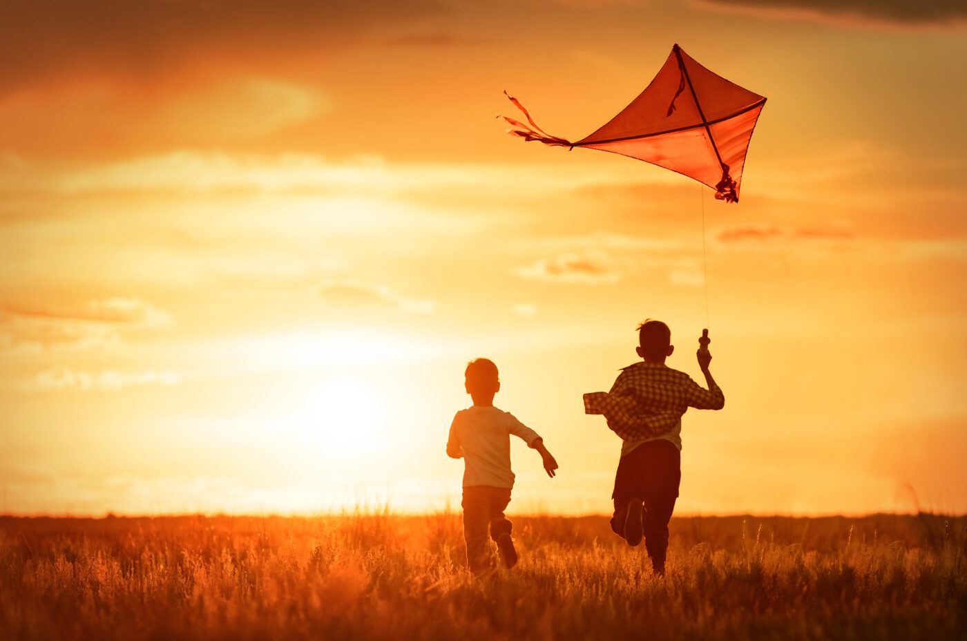 Children, Amir and Hassan fly a kite in the field at sunset, in Afghanistan in the Kite Runner at the Liverpool Playhouse, inspired by Khaled Hosseini's original New York bestselling novel.