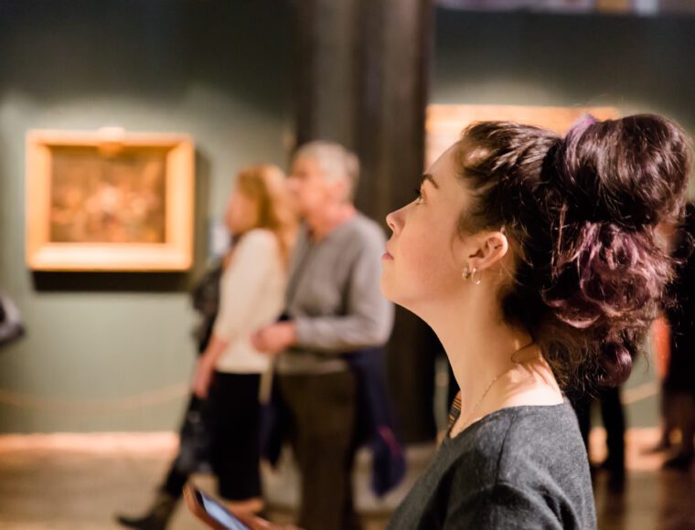 Young women looking at a painting in the Queen's Gallery at Buckingham Palace, Victoria, London.