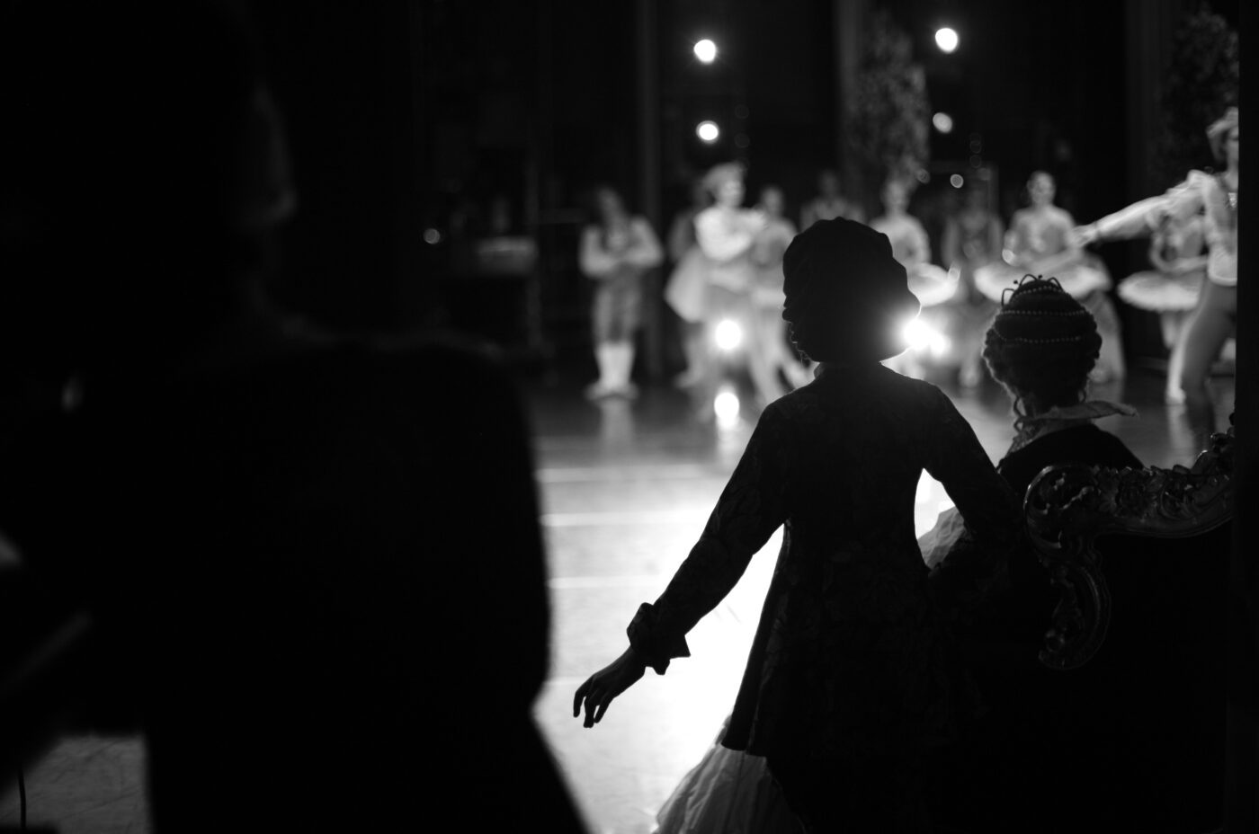Silhouettes of actors waiting in the wings at Wicked the musical