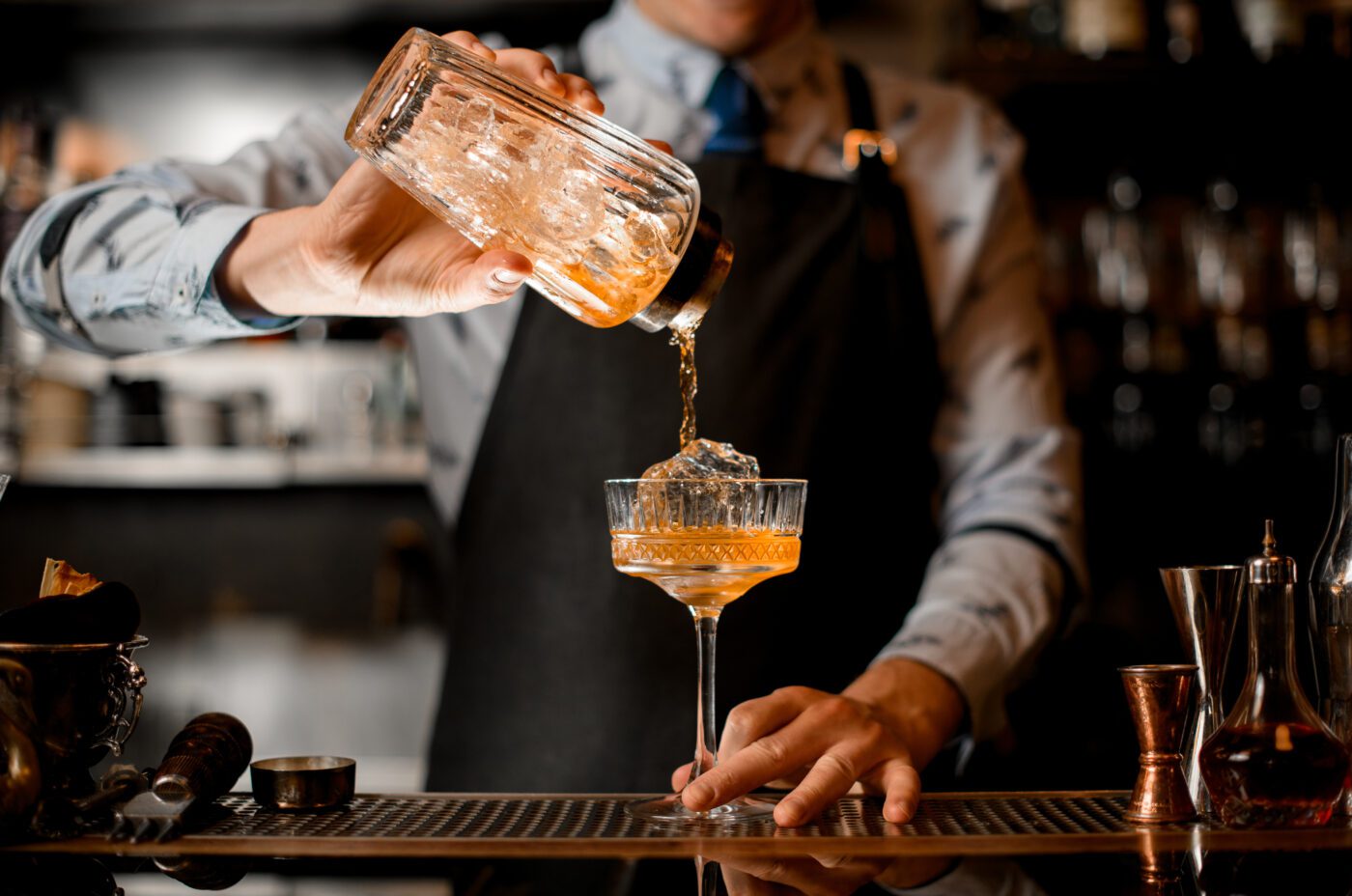 Barman gently pours finished cocktail during the London Cocktail Week celebrations