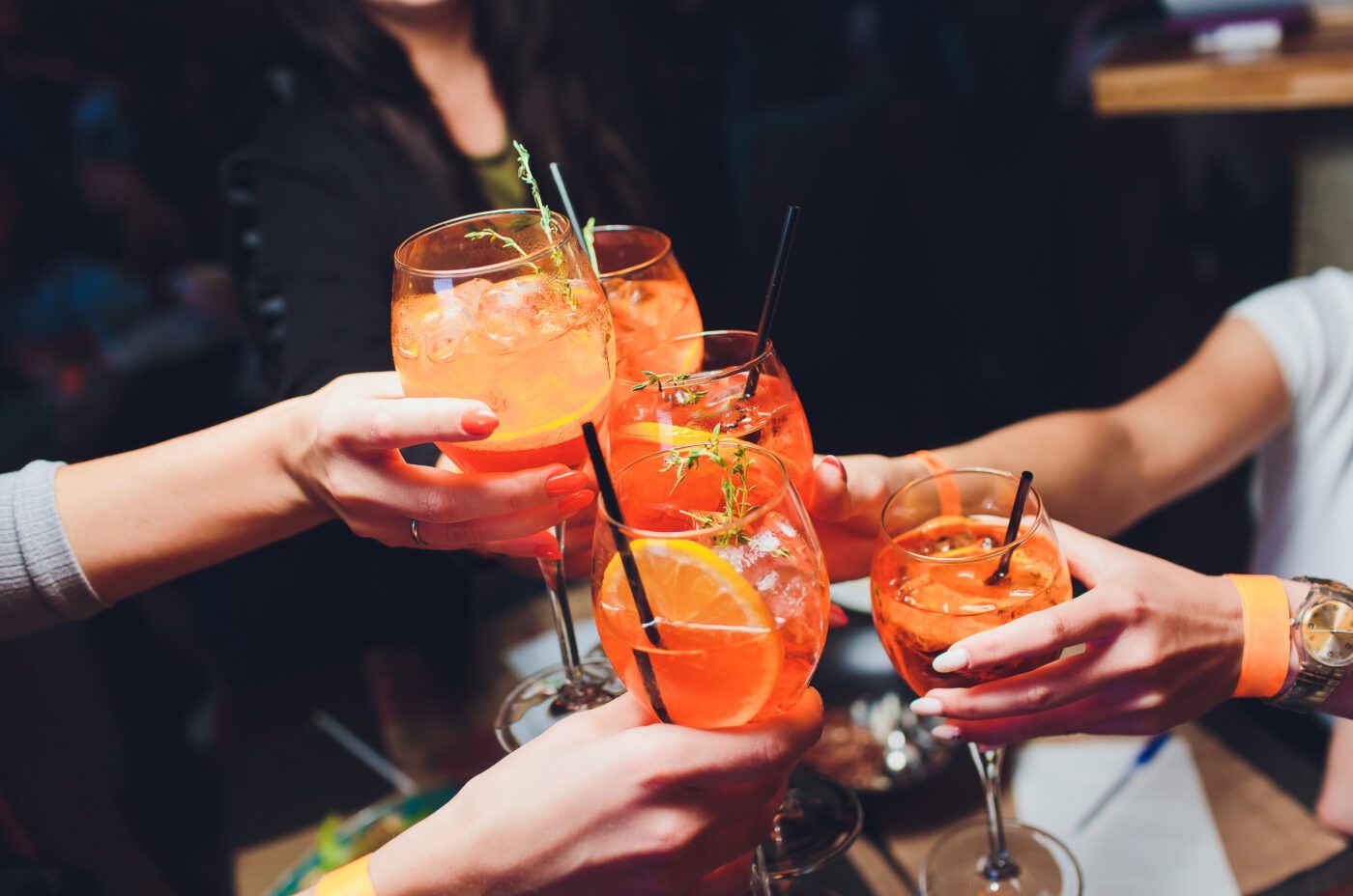 A group of women raising a glasses of aperol spritz during London Cocktail Week
