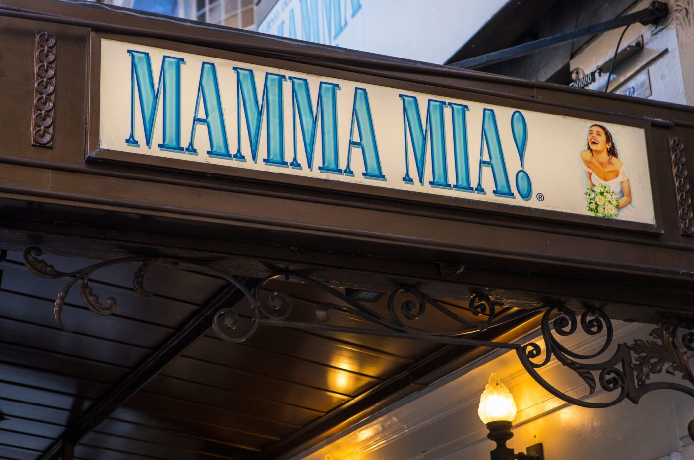 A theater marquee sign reads 