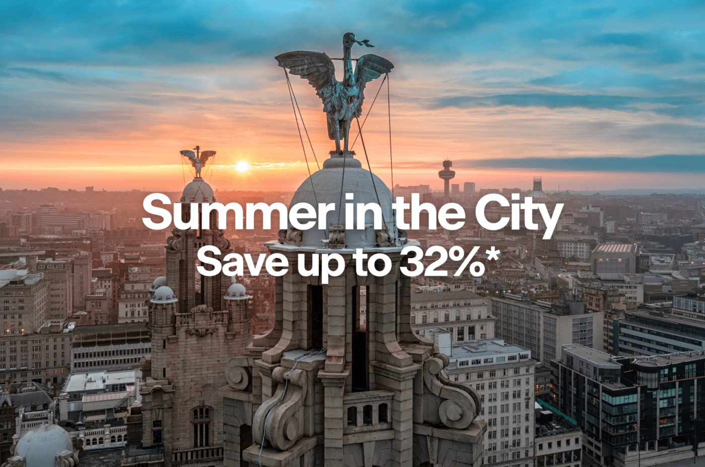 View of a city skyline at sunset with a large building featuring winged statues. Text over the image reads: 