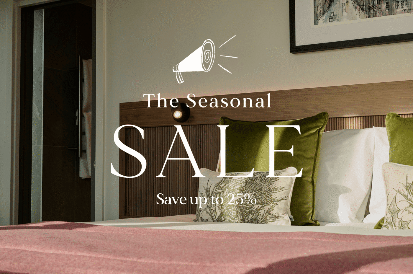 A modern hotel room with green and white cushions, a red blanket, and a framed artwork above the bed. Overlaid text reads: “The Seasonal SALE. Save up to 25%” with a megaphone icon.